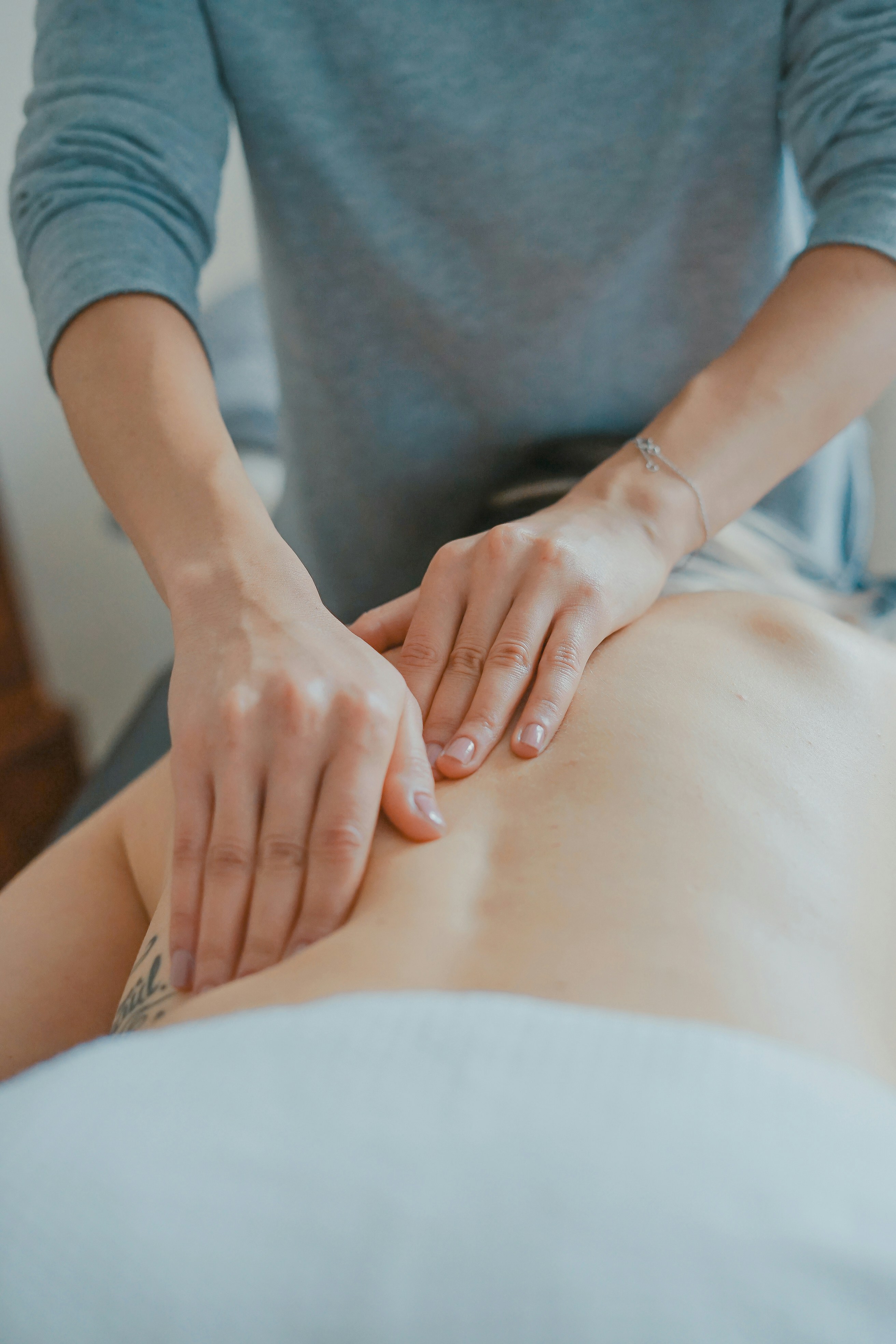 Healthcare professional administering myo-fascial release technique